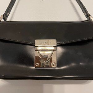 Guess, this shoulder bag is crafted in glossy leather with front logo hardware